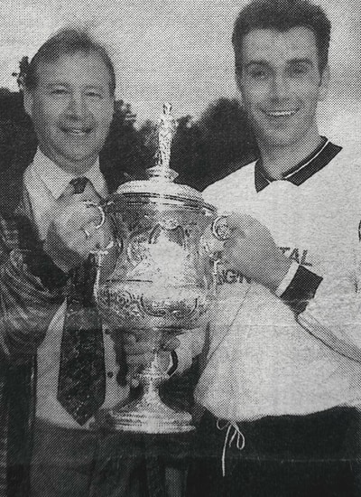 Derek Hodge presents Platt captain Pete Green with the Sevenoaks Charity Senior Cup for the third successive year in 1995 following their 3-0 win over Knockholt